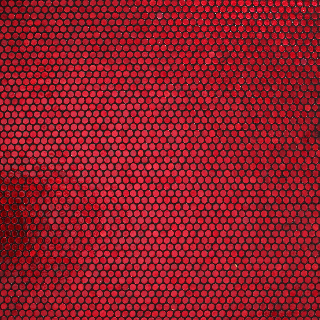 Red penny round glass mosaic wall creating a bold and dramatic interior look
