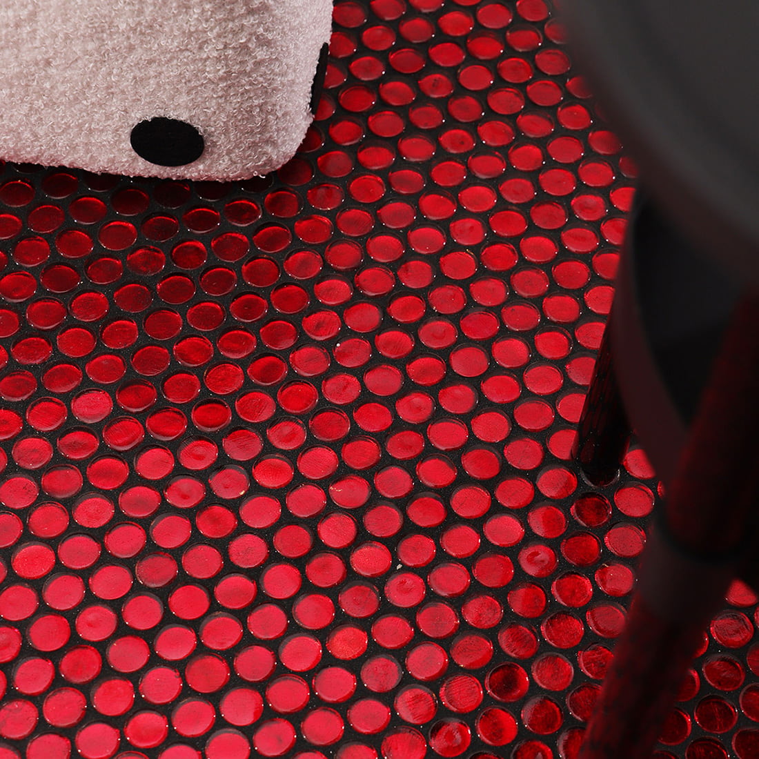 Close up of red round foil glass mosaic floor tiles with rich glossy finish