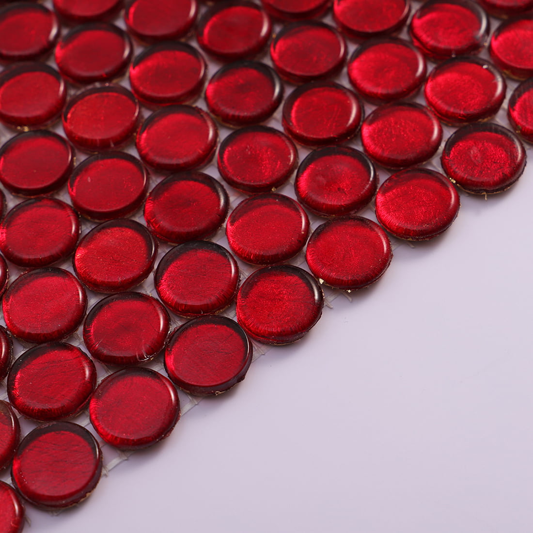Surface texture of red round foil glass mosaic tiles with metallic shine