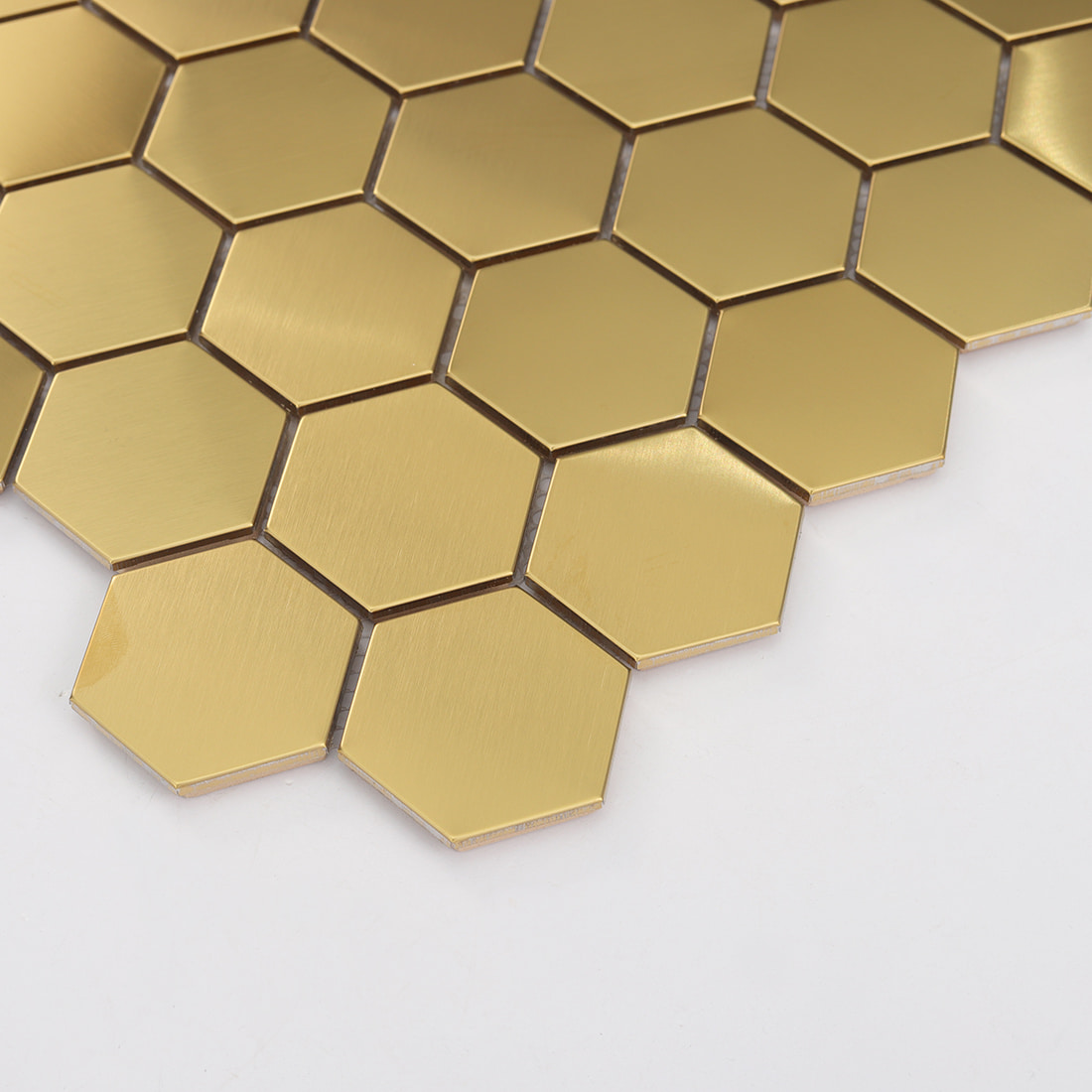 Detailed view highlighting the reflective quality and brushed texture of gold hexagon tiles