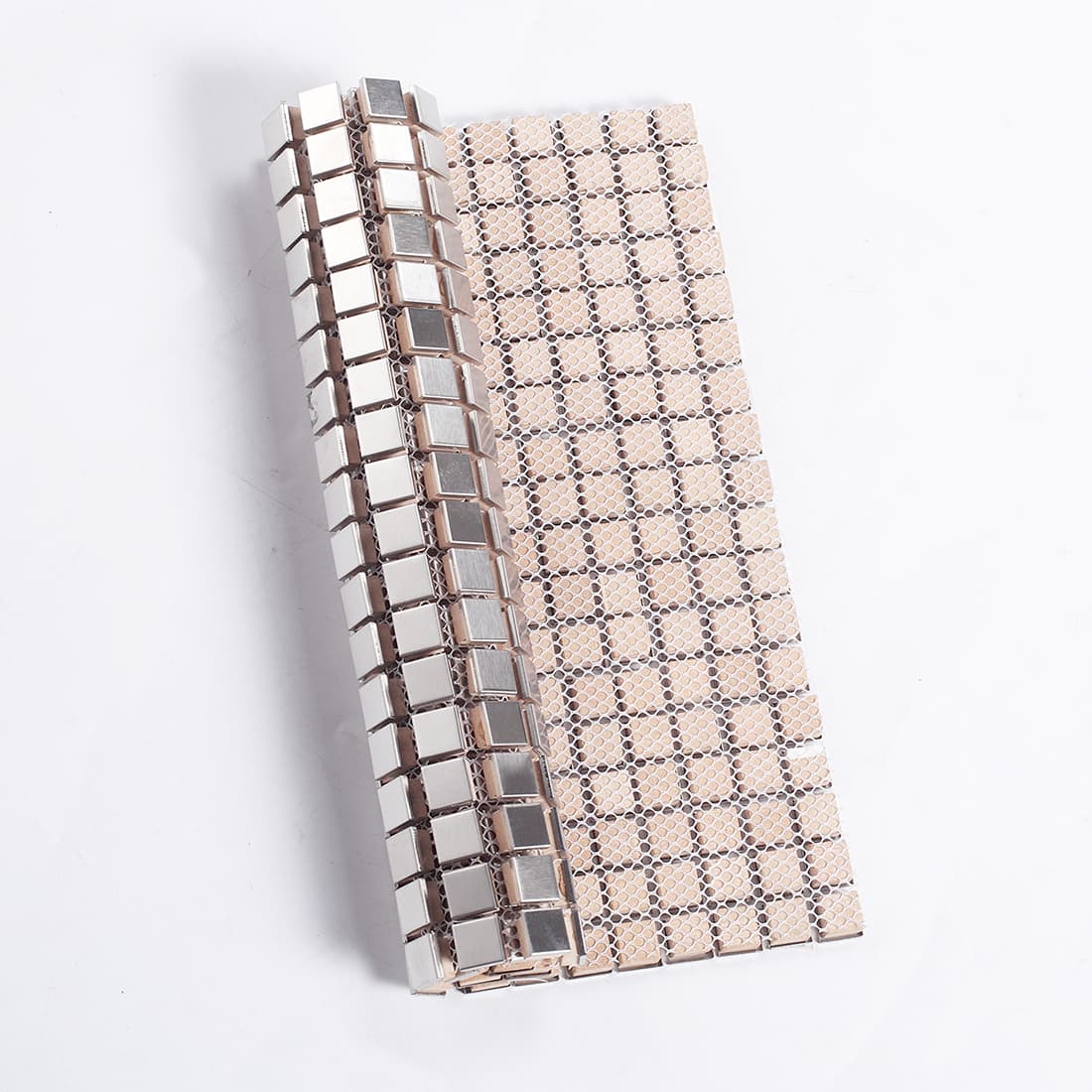 Rolled silver metal mosaic tile sheet revealing the mesh backing for easy installation.