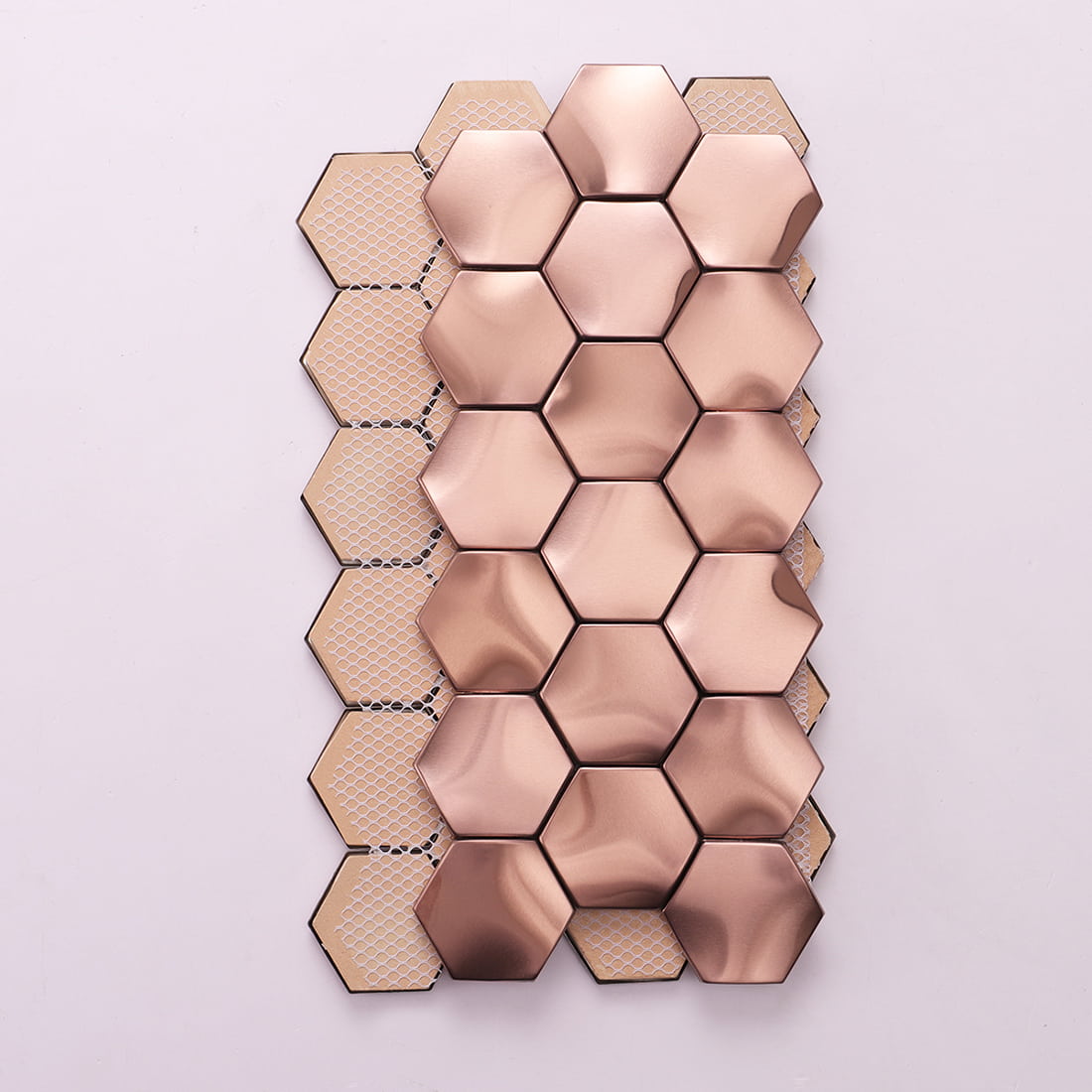 Back view of rose gold 3D hexagon mosaic tiles showing the fiber mesh backing.