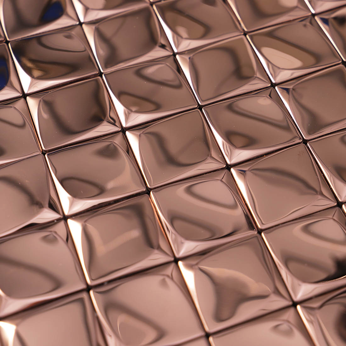 Close-up of reflective rose gold 3D square metal mosaic tile surface