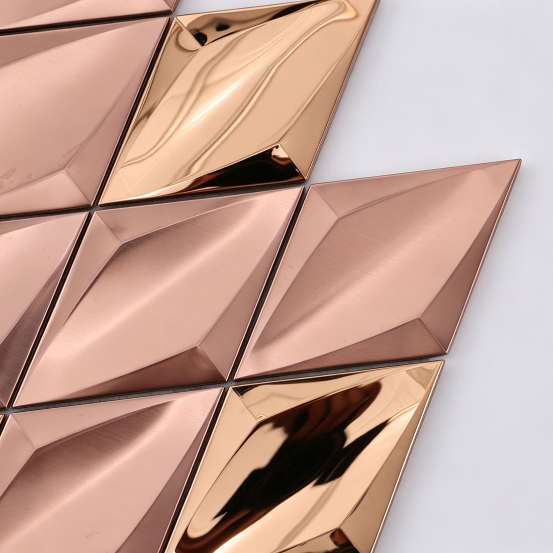 Close-up of rose gold and polished gold diamond metal mosaic tiles
