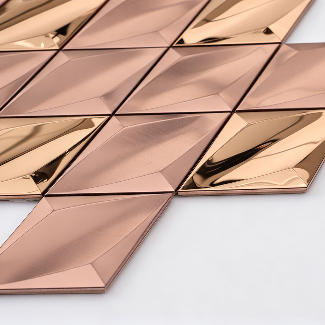 Rose gold diamond metal mosaic tile edge showing faceted surface detail