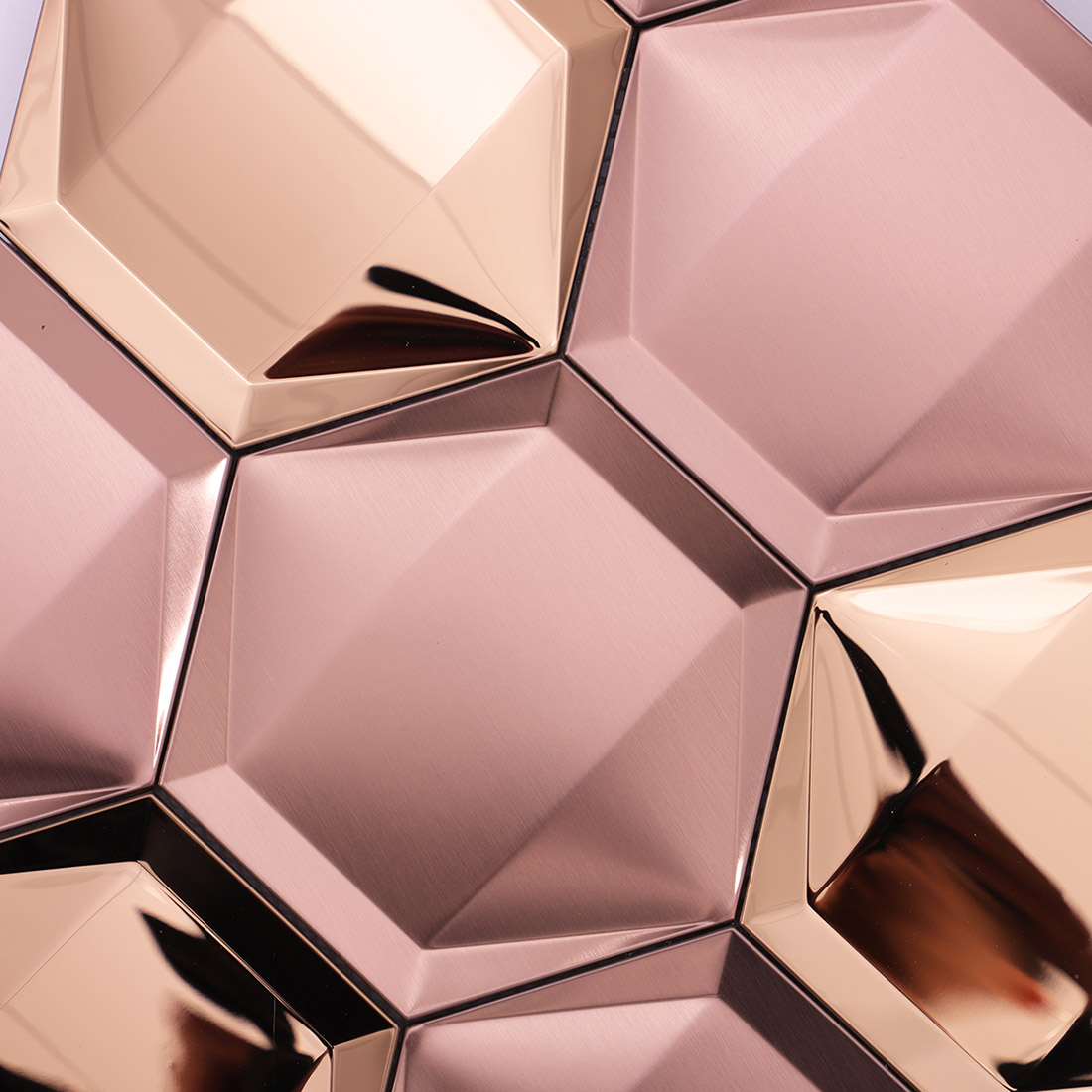 Rose gold 3D hexagon mosaic showing brushed and mirrored metal surfaces