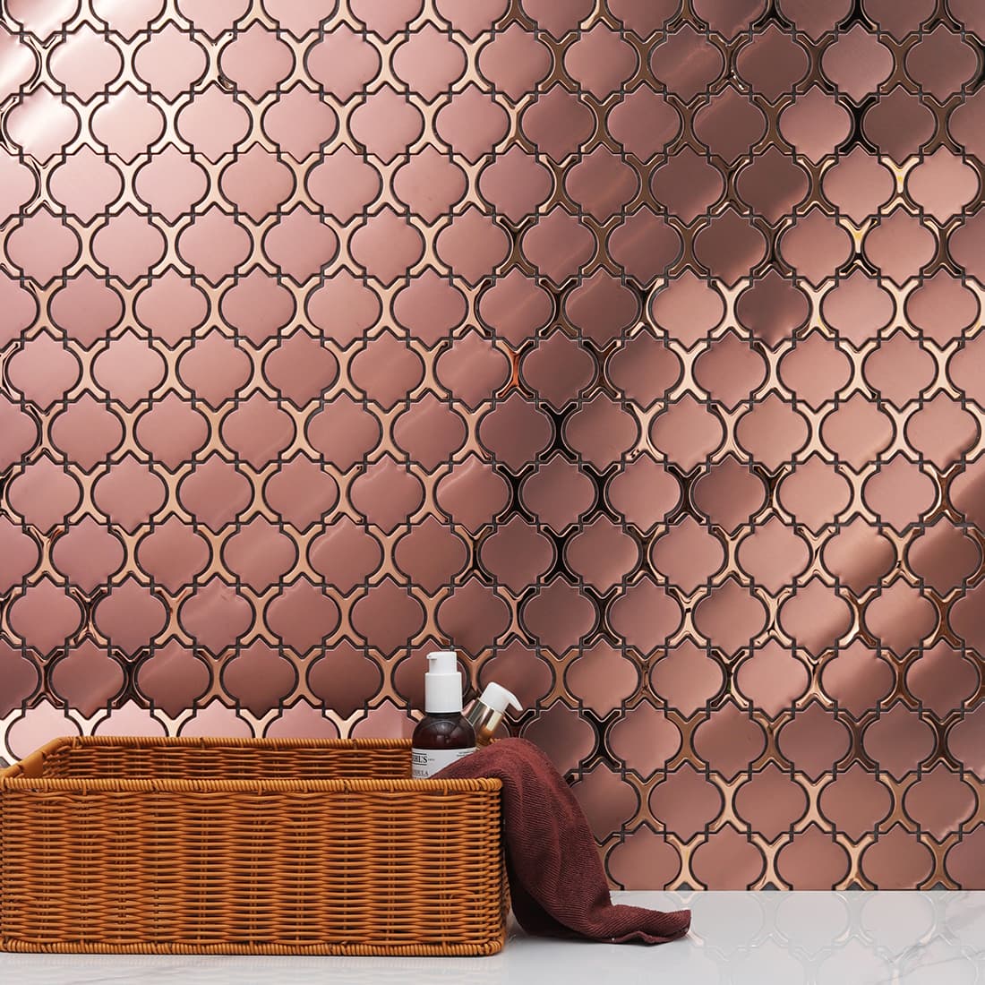 Rose gold lantern stainless steel wall tile behind a vanity basket display