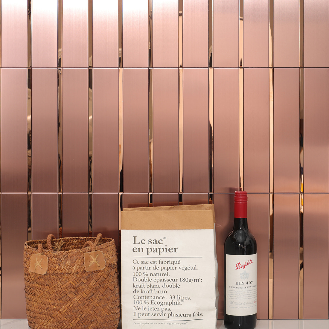 Full view of rose gold metal mosaic tile wall with decorative props