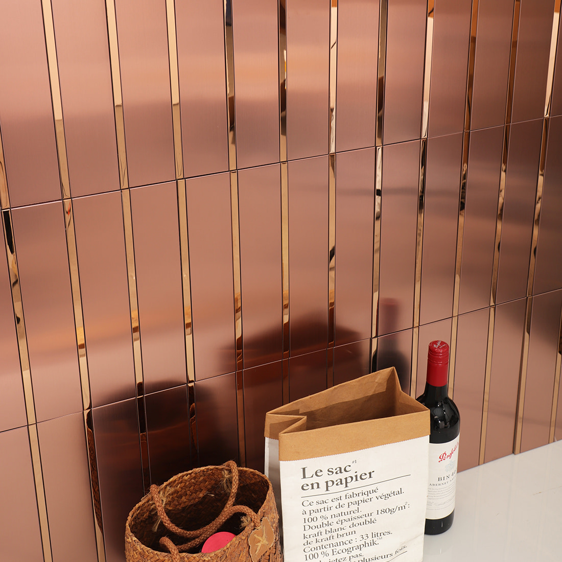 Close-up of rose gold mosaic tile wall with reflective surface