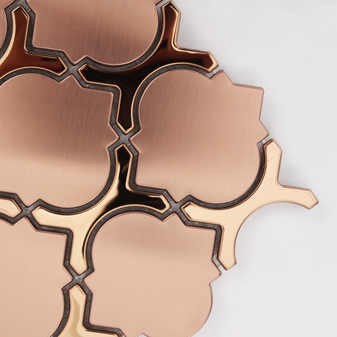 Close-up of rose gold stainless steel lantern mosaic edge and curved detail