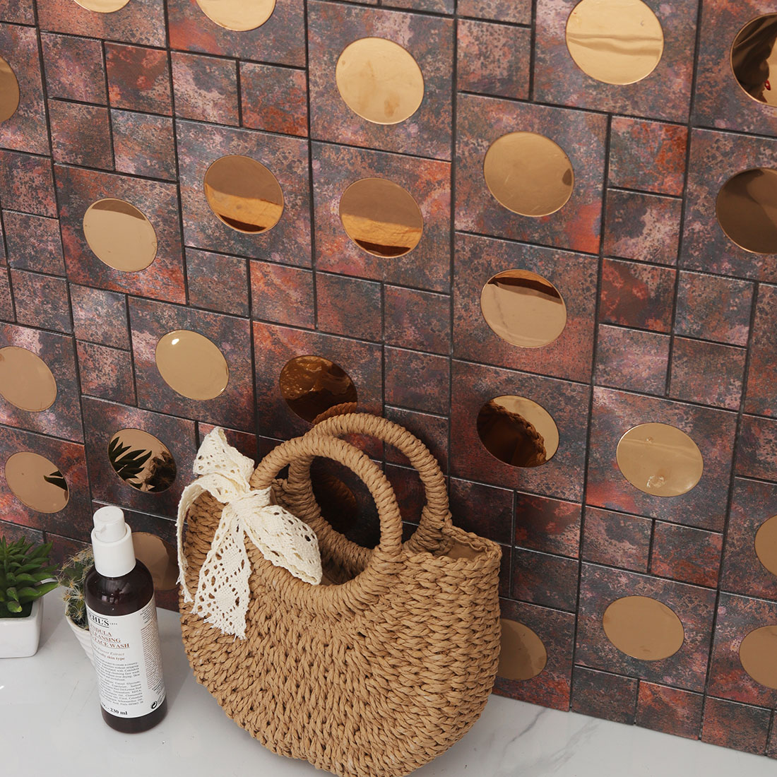 Rustic copper aluminum mosaic tile creates a warm powder room accent wall