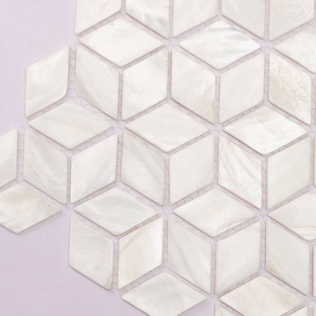 Geometric cube pattern formed by white shell mosaic tiles