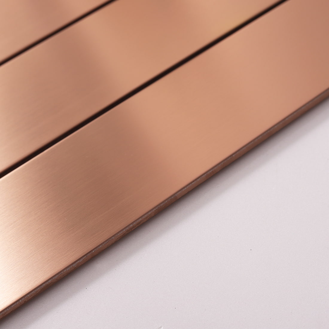 Side view showing the thickness and black core of rose gold metal tile.