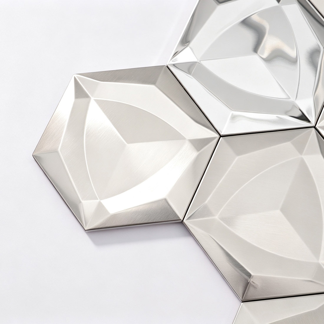 Close-up of silver 3D hexagon stainless steel mosaic tiles with brushed finish