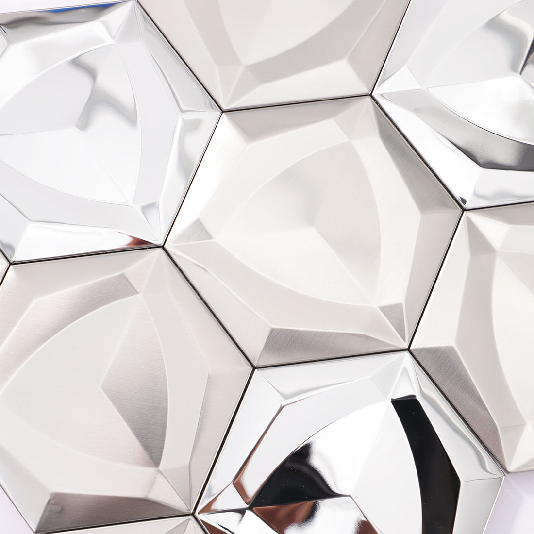 Silver 3D hexagon mosaic tile surface with brushed and mirrored metal finishes