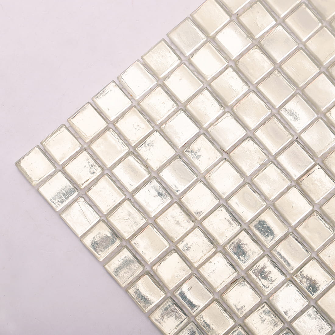 Diagonal corner close-up of reflective silver glass foil mosaic tiles