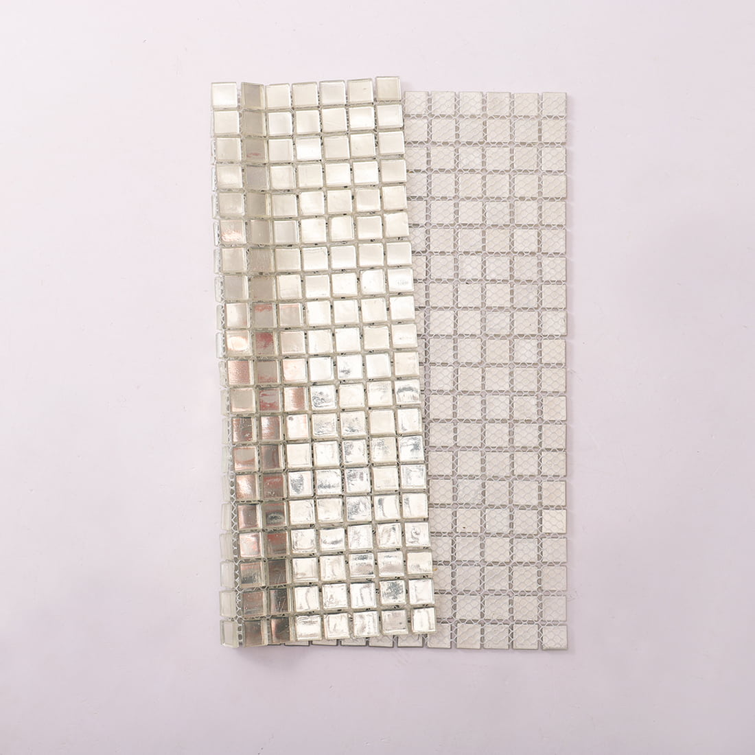 Side view of silver glass foil mosaic tile sheet with fiberglass mesh backing