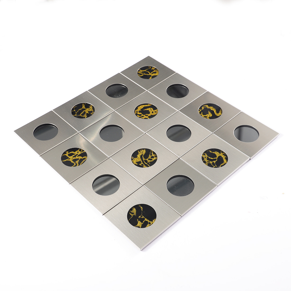 Angled shot of silver brushed metal mosaic with round glass inlay