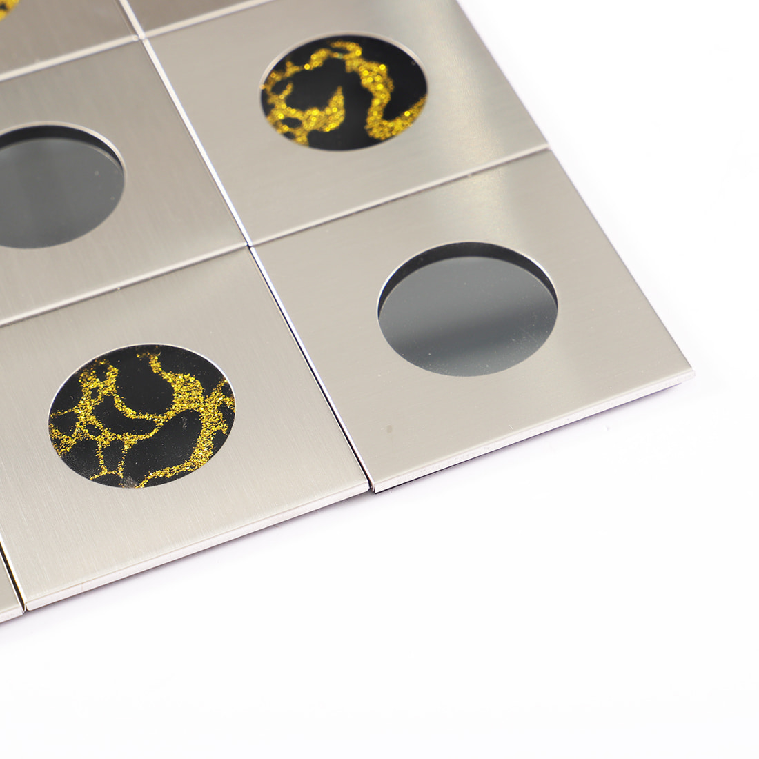 Detail of silver brushed metal square mosaic with round glass decoration