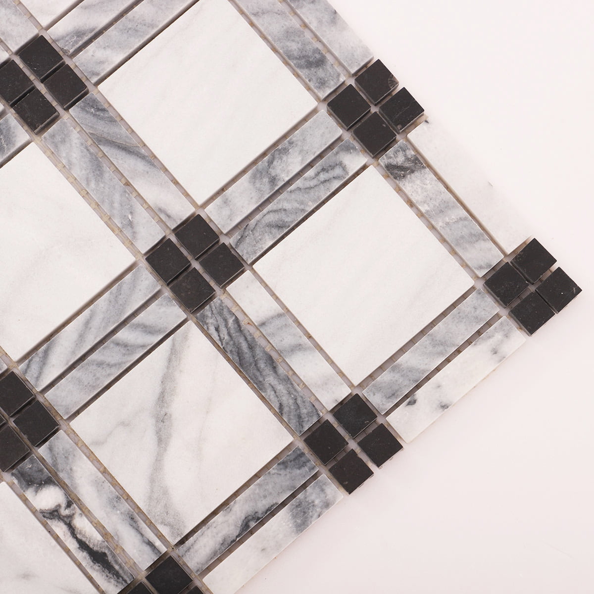 Angled close-up of white marble squares framed by gray strips and black dot corners.