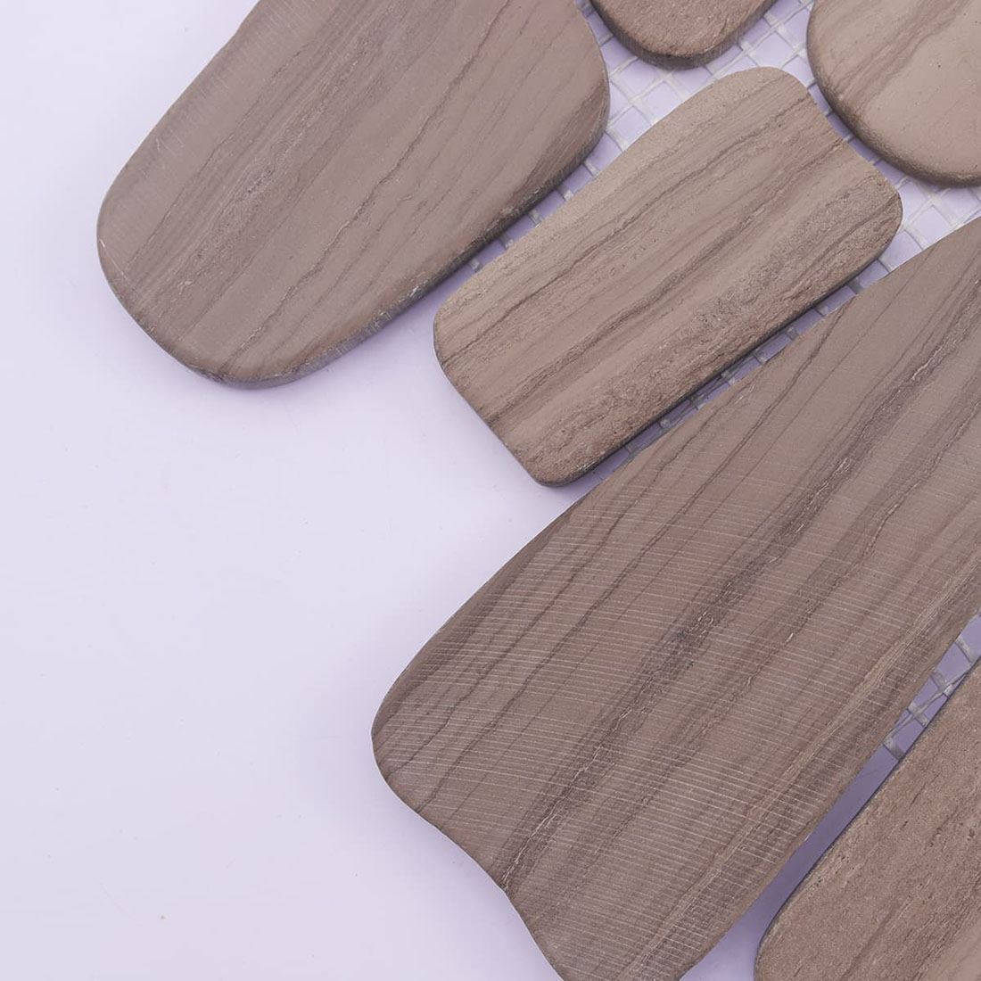 Close-up of taupe pebble stone mosaic with fine linear natural texture