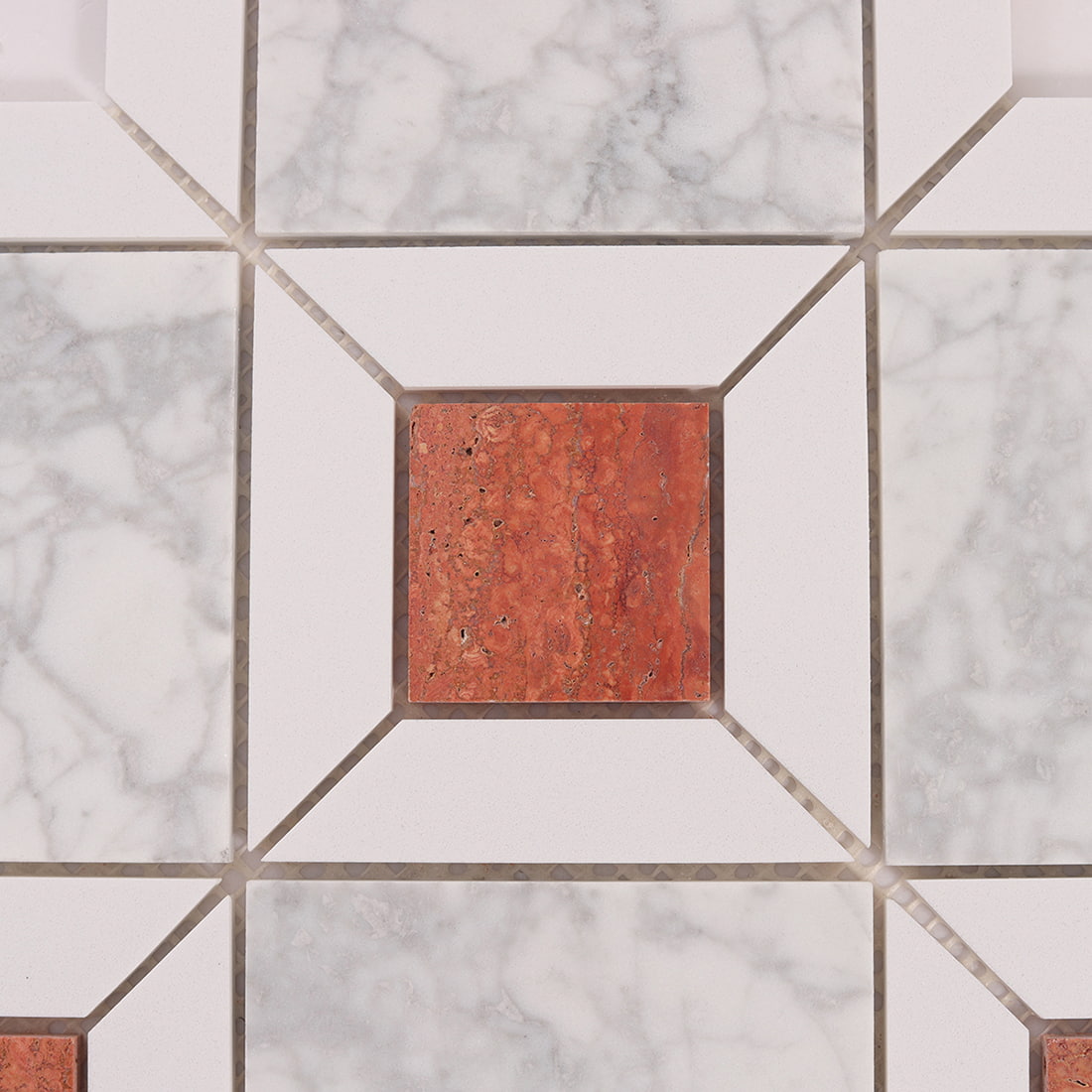 Detail of terracotta stone accent surrounded by white marble mosaic tiles