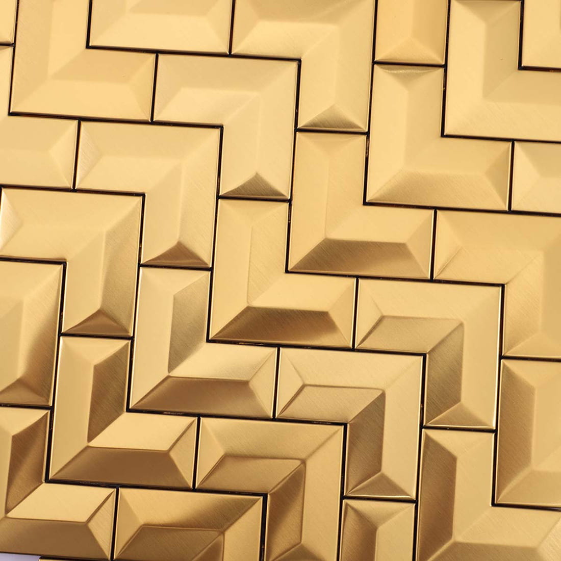 Detailed texture and finish of brushed gold V-shape metal mosaic tiles.