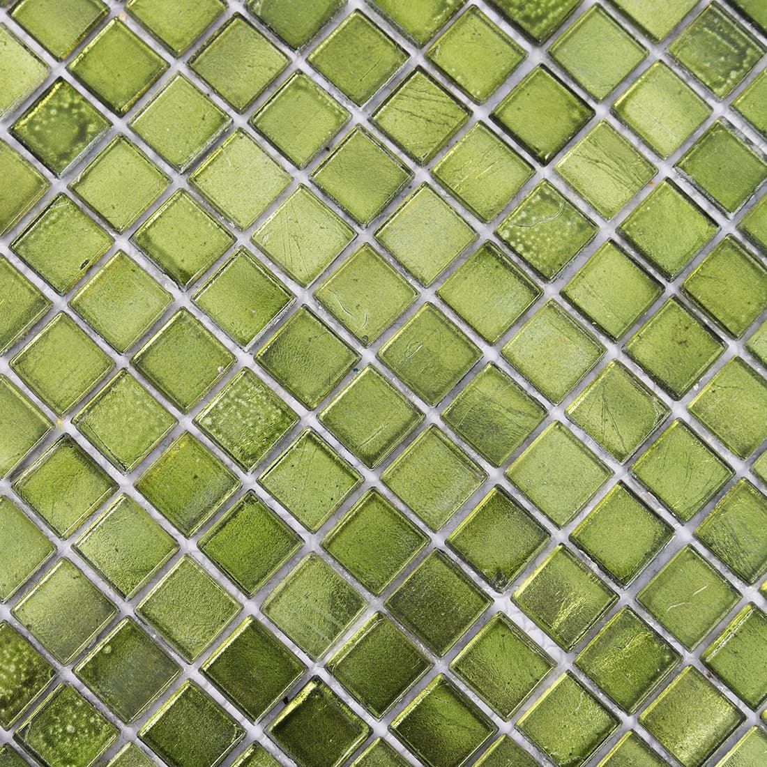 Macro shot of green glass mosaic tiles showing subtle color variations and surface texture