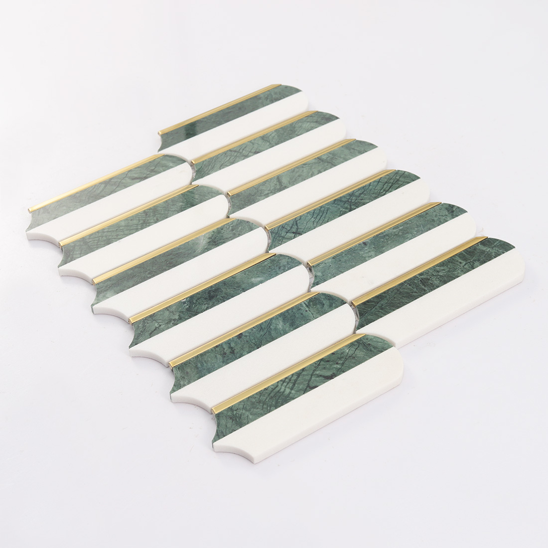 Angled display of white and dark green elongated marble mosaic with gold strips