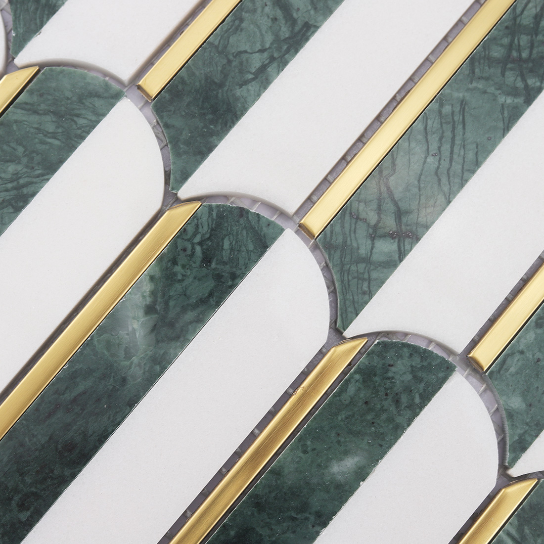 Detailed view of elongated white and dark green marble tiles with gold lines
