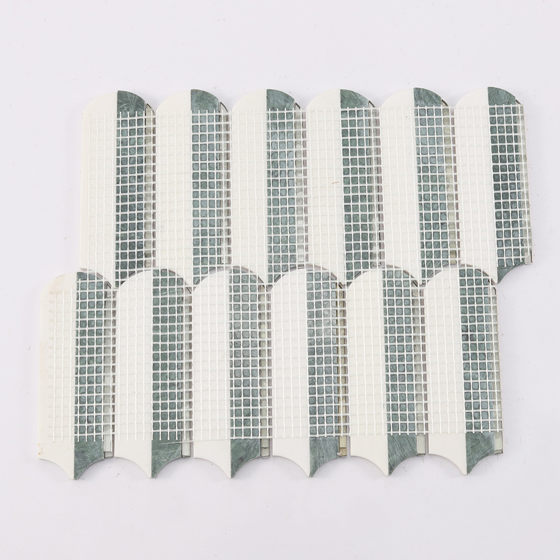 Back view of white and dark green marble mosaic tile sheet with mesh backing