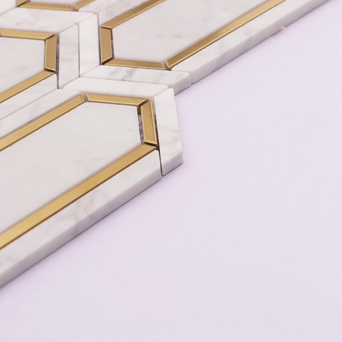 Side edge of white gold elongated hexagon marble mosaic tile with metal inlay