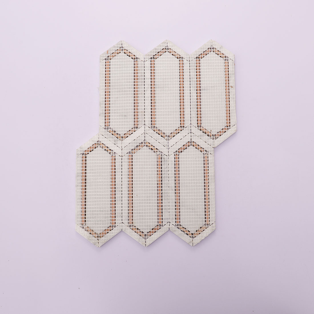 Back view of white gold elongated hexagon marble mosaic tile sheet with mesh backing