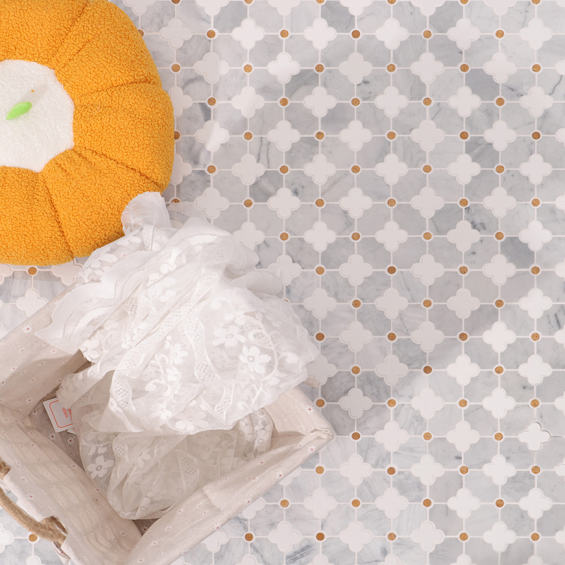 Installed clover marble mosaic surface with basket and lace fabric styling