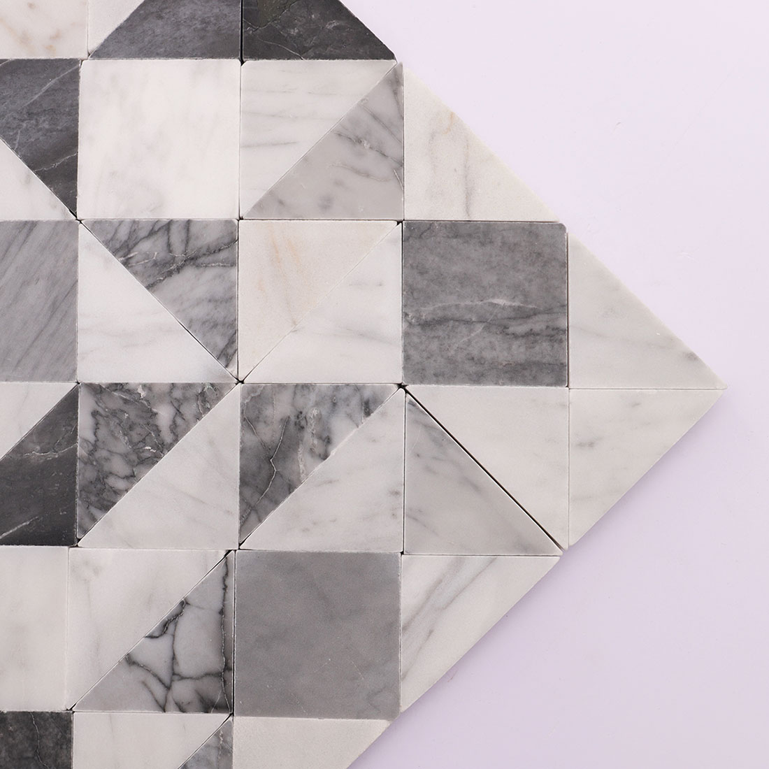 Corner detail of white gray geometric marble mosaic tile with triangular pieces