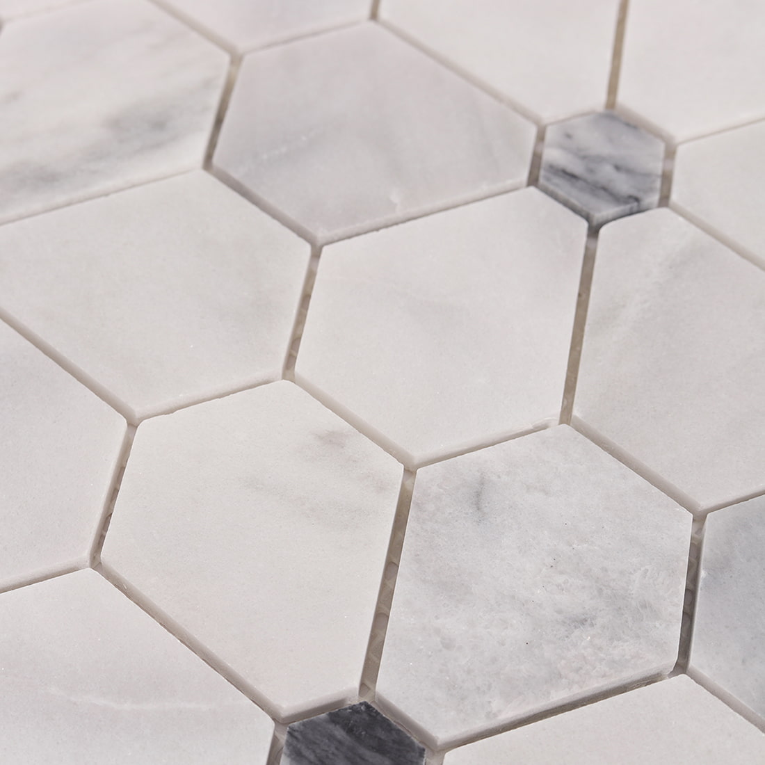 Detailed view of white and gray hexagon marble tiles with grout joints
