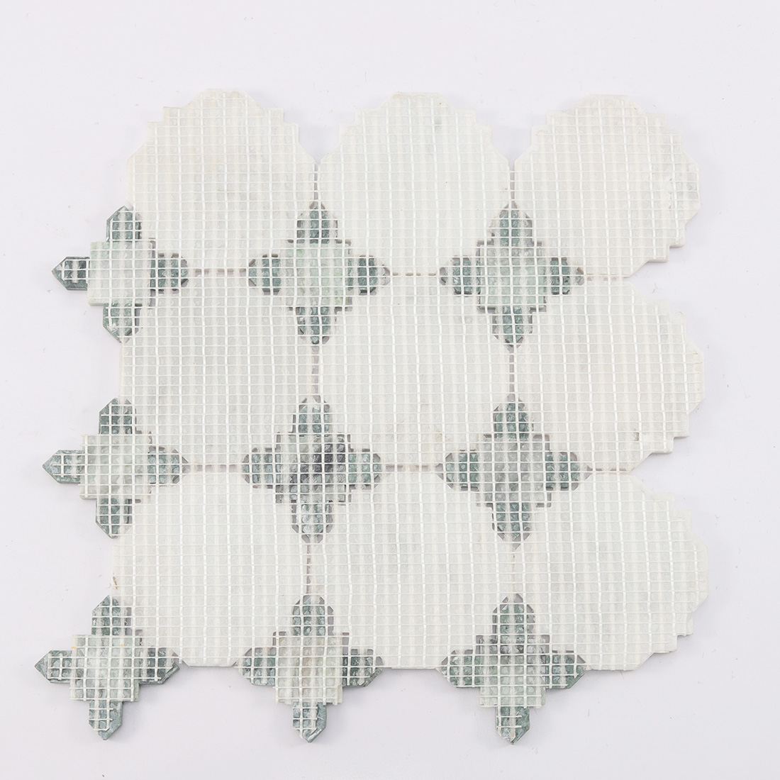 Back view of white octagon marble mosaic with green corners on mesh backing