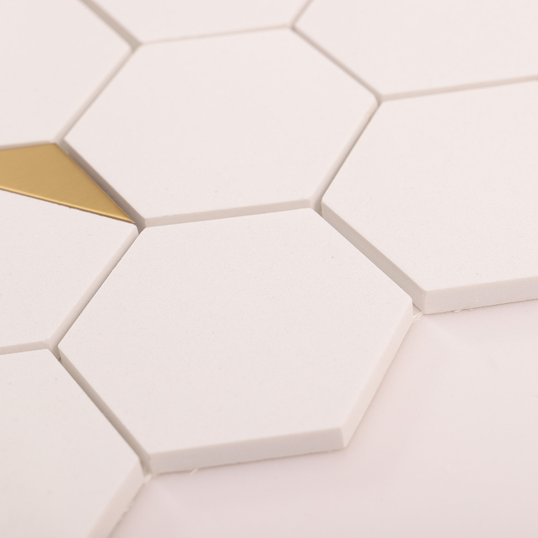 Close-up of smooth white hexagon tile surface and edges