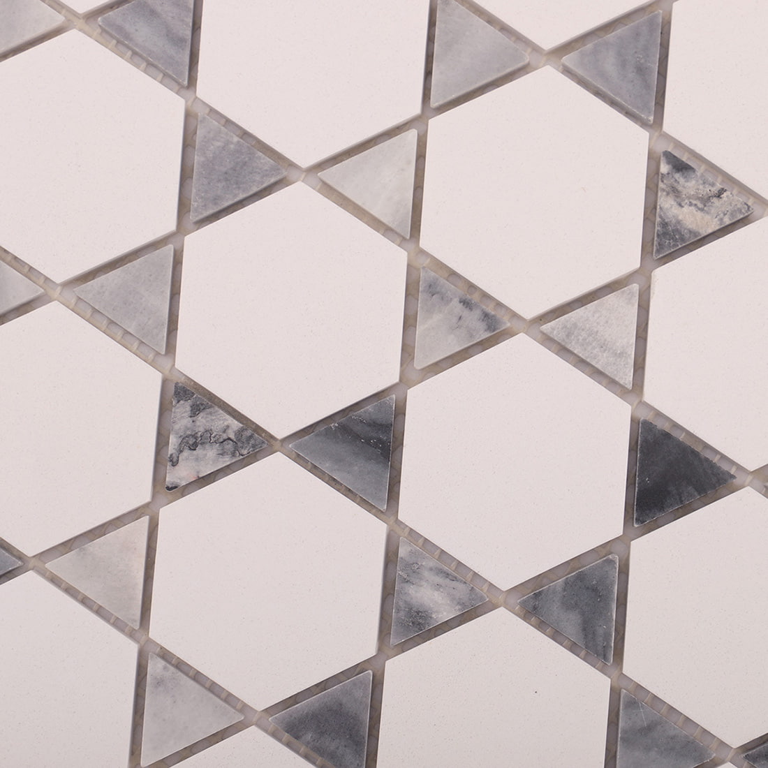 Surface texture view of white hexagon marble mosaic with triangle accents