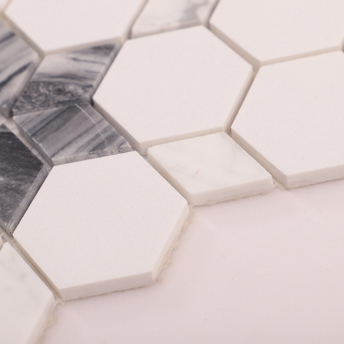 Macro shot showing white hexagon mosaic tile edges and thickness.