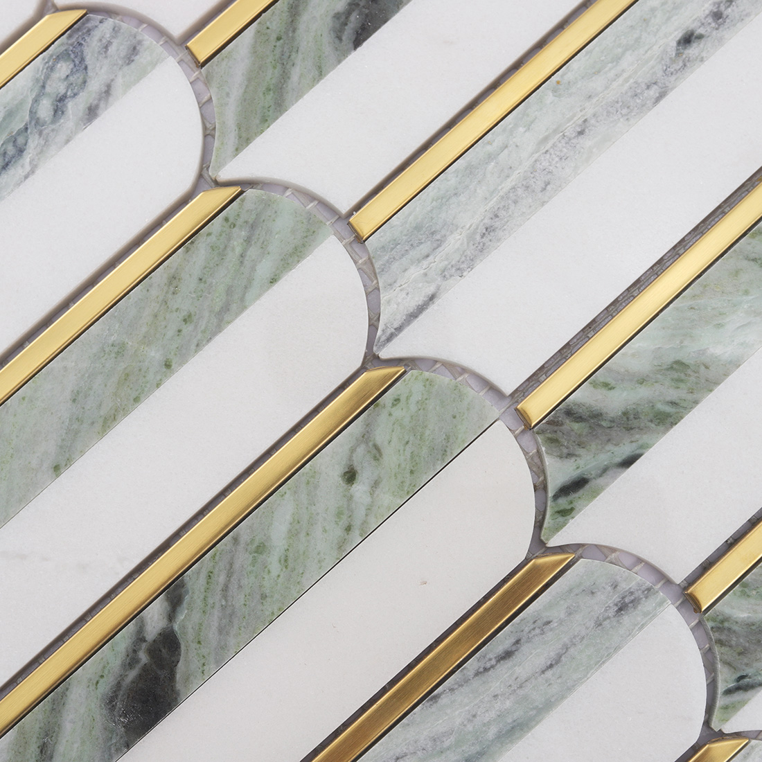 Detailed view of elongated white light green marble tiles with gold lines