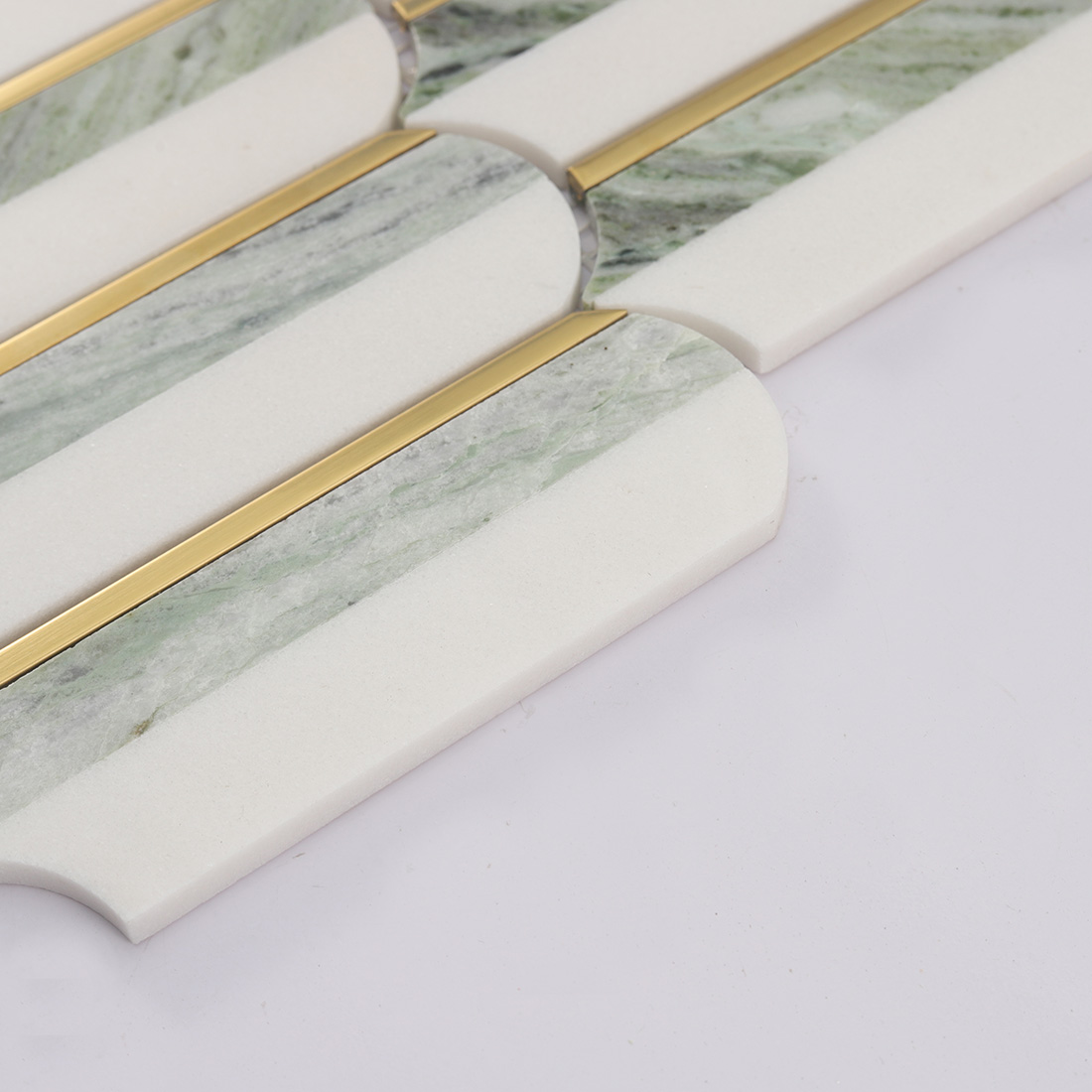 Side view showing thickness of white light green marble mosaic with gold trim