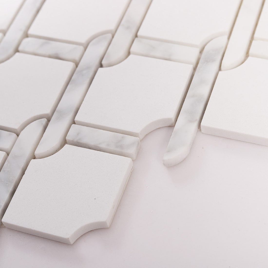 Angled close up showing thickness of white marble chain link mosaic tiles