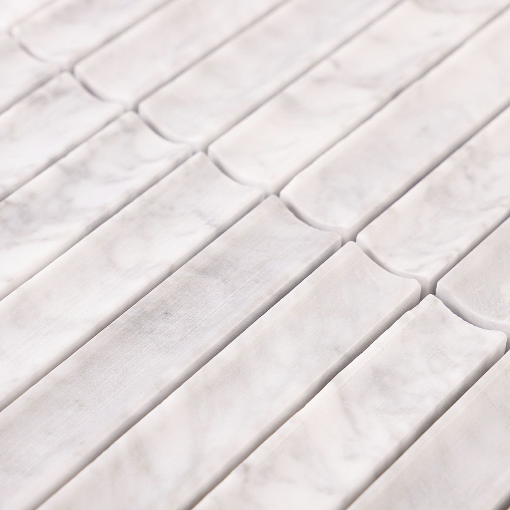 Close-up of white marble strip tiles with curved interlocking ends