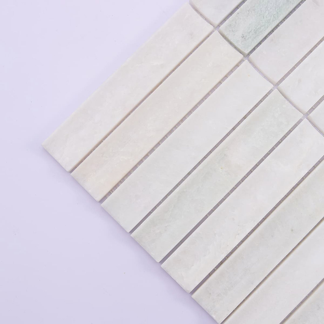 Close-up of white marble strip mosaic showing soft natural color variation