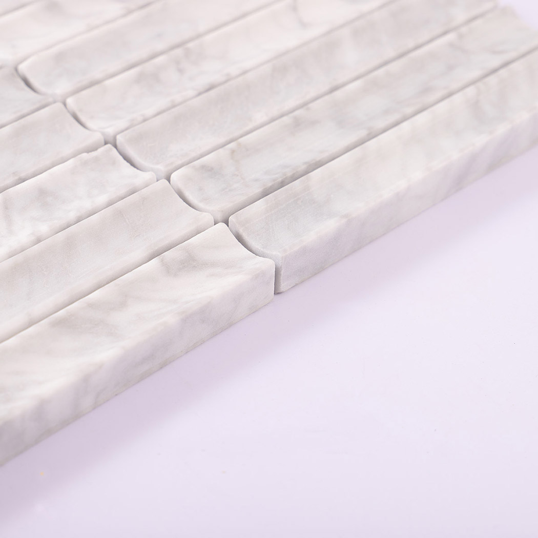Angled edge view of white marble strip mosaic tiles with a matte finish