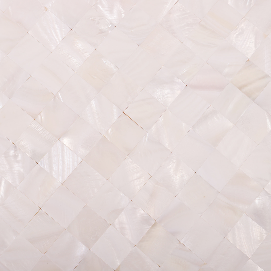 Close-up of white mother of pearl mosaic showing glossy square chip texture