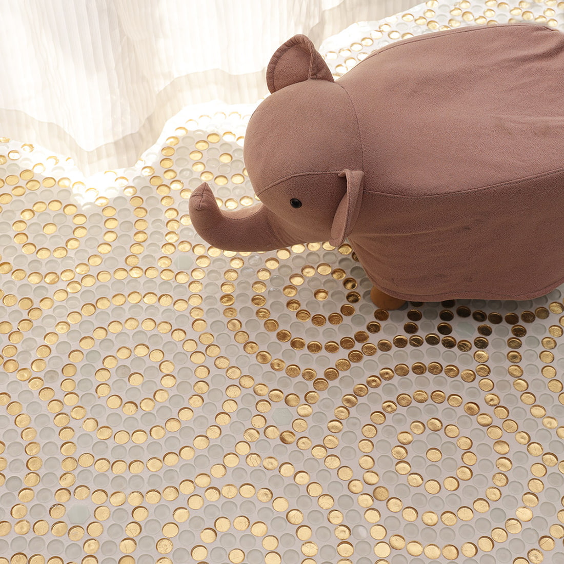 Decorative scene showing white and gold round glass mosaic floor surface