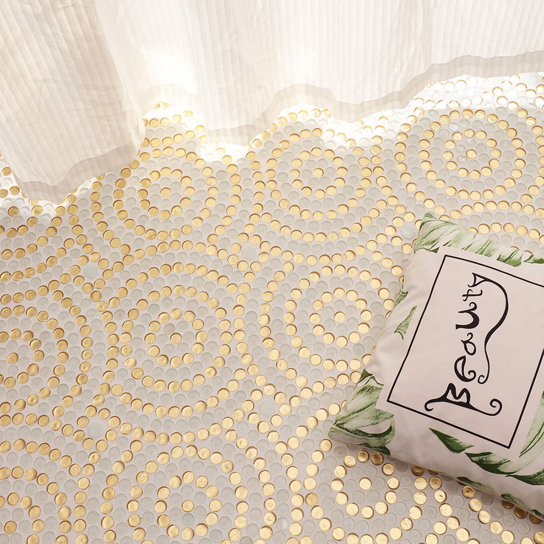 White and gold round glass mosaic floor styled with home decor accessories