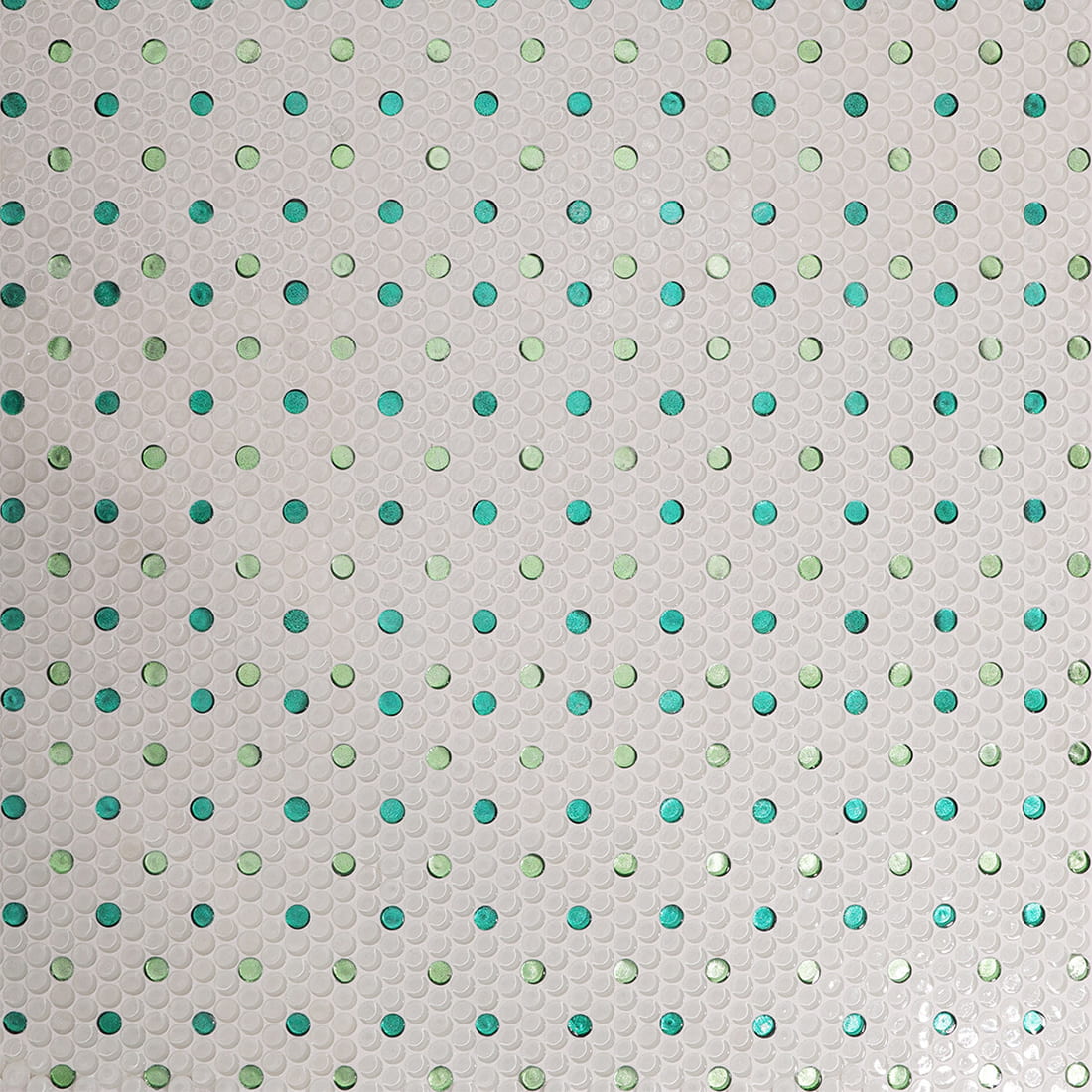 Installed white penny round glass mosaic tile with green foil dots on floor